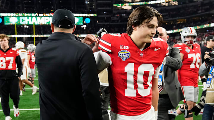 Ohio State Buckeyes quarterback Julian Sayin (10) hugs head coach Ryan Day following the Cotton Bowl at AT&T Stadium in Arlington, Texas for the College Football Playoff quarterfinal game on Dec. 31, 2025. Ohio State lost 24-14.