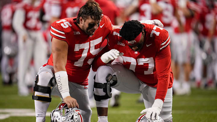 Ohio State Buckeyes offensive linemen Carson Hinzman (75) and Tegra Tshabola (77) pray prior to the NCAA football game against the UCLA Bruins at Ohio Stadium in Columbus on Nov. 15, 2025.