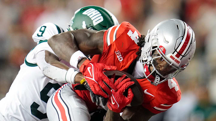 Ohio State Buckeyes wide receiver Jeremiah Smith (4) catches a 47-yard touchdown pass in front of Ohio Bobcats cornerback Michael Mack II (9) during the second half of the NCAA football game at Ohio Stadium on Sept. 13, 2025. Ohio State won 37-9.