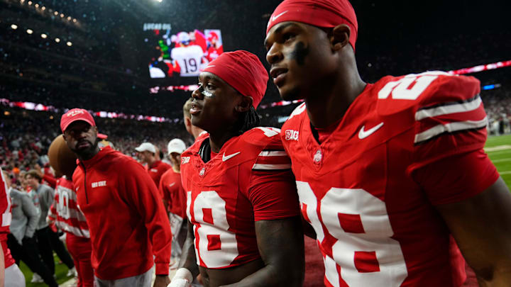 Ohio State Buckeyes safety Jaylen McClain (18) and safety Leroy Roker (28) leave the field following the Big Ten Conference championship game against the Indiana Hoosiers at Lucas Oil Stadium in Indianapolis on Dec. 6, 2025. Ohio State lost 13-10.
