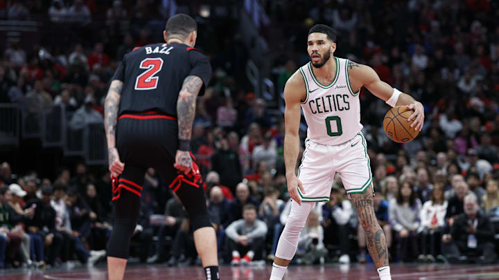 Boston Celtics forward Jayson Tatum (0) brings the ball up court against Chicago Bulls guard Lonzo Ball (2) during the second half at United Center. Mandatory Credit: Kamil Krzaczynski-Imagn Images