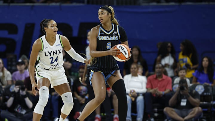 Jul 12, 2025; Chicago, Illinois, USA; Minnesota Lynx forward Napheesa Collier (24) defends against Chicago Sky forward Angel Reese (5) during the first half of a WNBA game at Wintrust Arena. 