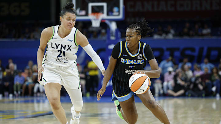 Jul 12, 2025; Chicago, Illinois, USA; Chicago Sky guard Ariel Atkins (7) drives to the basket against Minnesota Lynx guard Kayla McBride (21) during the second half of a WNBA game at Wintrust Arena. Mandatory Credit: Kamil Krzaczynski-Imagn Images