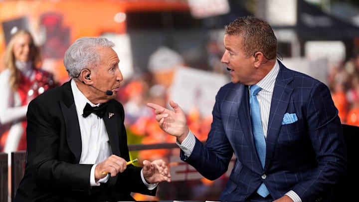 Lee Corso, middle, talks to Kirk Herbstreit on the set of ESPN College GameDay for his final show prior to a NCAA football game.