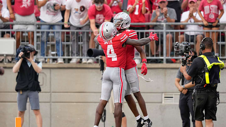 Aug 31, 2024; Columbus, OH, USA; Ohio State Buckeyes wide receiver Jeremiah Smith (4) celebrates a touchdown by wide receiver Carnell Tate (17) during the second half of the NCAA football game against the Akron Zips at Ohio Stadium. Ohio State won 52-6.