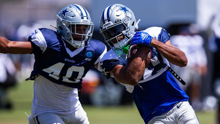 Dallas Cowboys wide receiver Jalen Tolbert keeps the ball from safety Juanyeh Thomas during training camp 