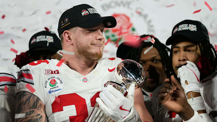 Ohio State Buckeyes defensive end Jack Sawyer (33) holds the Leishman Trophy following the College Football Playoff quarterfinal against the Oregon Ducks at the Rose Bowl in Pasadena, Calif. on Jan. 1, 2025. Ohio State won 41-21.