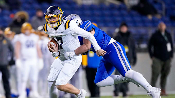 Cincinnati Moeller's Matt Ponatoski (7) runs the ball against Olentangy Liberty in the first half of the Division I State Championship game at Tom Benson Hall of Fame Stadium on Friday, Dec. 6, 2024 in Canton, Ohio. Cincinnati Moeller's Matt Ponatoski (7) runs the ball against Olentangy Liberty in the first half of the Division I State Championship game at Tom Benson Hall of Fame Stadium on Friday, Dec. 6, 2024 in Canton, Ohio.
