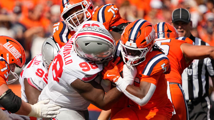 Ohio State Buckeyes defensive lineman Kayden McDonald (98) strips the ball from Illinois Fighting Illini running back Ca'Lil Valentine (5) and recovers the fumble during the first half of the NCAA football game at Gies Memorial Stadium in Champaign on Oct. 11, 2025. Ohio State Buckeyes defensive lineman Kayden McDonald (98) strips the ball from Illinois Fighting Illini running back Ca'Lil Valentine (5) and recovers the fumble during the first half of the NCAA football game at Gies Memorial Stadium in Champaign on Oct. 11, 2025.