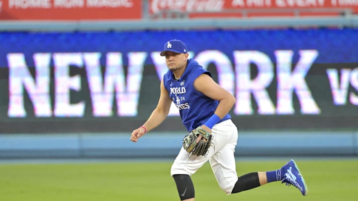 Oct 24, 2024; Los Angeles, CA, USA;  Los Angeles Dodgers shortstop Miguel Rojas (11) during the team workout prior to game one of the World Series against the New York Yankees at Dodger Stadium. Mandatory Credit: Jayne Kamin-Oncea-Imagn Images