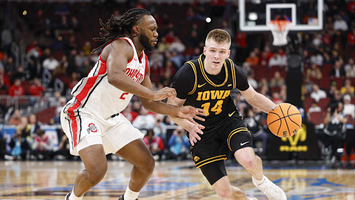 Mar 12, 2026; Chicago, IL, USA; Iowa Hawkeyes guard Bennett Stirtz (14) drives to the basket against Ohio State Buckeyes guard Bruce Thornton (2) during the first half at United Center. Mandatory Credit: Kamil Krzaczynski-Imagn Images