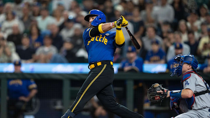 Seattle Mariners Eugenio Suarez (28) takes a swing during an at-bat against the Los Angeles Dodgers at T-Mobile Park in 2023.