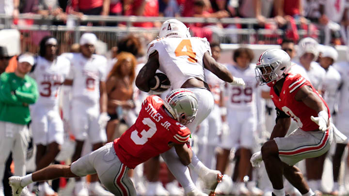 Ohio State Buckeyes cornerback Lorenzo Styles Jr. (3) and safety Faheem Delane (10) stop Texas Longhorns running back CJ Baxter (4).