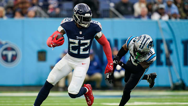 Tennessee Titans running back Derrick Henry (22) evades Carolina Panthers cornerback David Long Jr. (20) during the fourth quarter at Nissan Stadium in Nashville, Tenn., Sunday, Nov. 26, 2023.