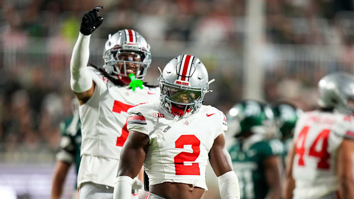 Sep 28, 2024; East Lansing, Michigan, USA; Ohio State Buckeyes safety Caleb Downs (2) celebrates after tackling Michigan State Spartans running back Nate Carter (5) in the first half at Spartan Stadium on Saturday.