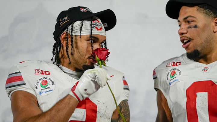 Ohio State Buckeyes wide receiver Emeka Egbuka (2) smells a rose following the College Football Playoff quarterfinal against the Oregon Ducks at the Rose Bowl in Pasadena, Calif. on Jan. 1, 2025. Ohio State won 41-21.