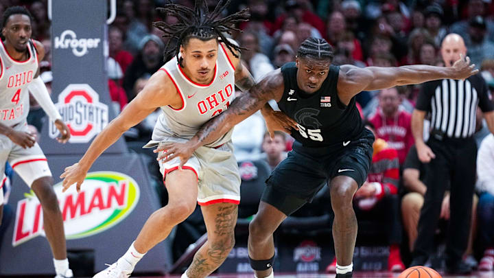 Ohio State Buckeyes forward Devin Royal (21) fights for the ball against Michigan State Spartans forward Coen Carr (55) in the first half at Value City Arena on Friday, Jan. 3, 2025 in Columbus, Ohio.