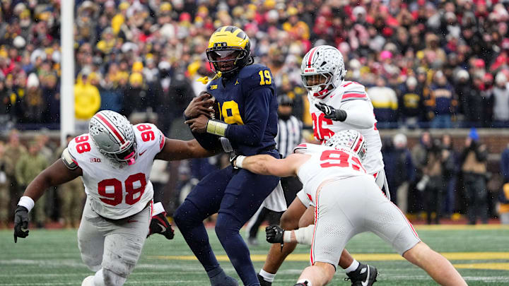 Ohio State Buckeyes defensive end Caden Curry (92) abd defensive tackle Kayden McDonald (98) hit Michigan Wolverines quarterback Bryce Underwood (19) during the NCAA football game at Michigan Stadium in Ann Arbor, Mich. on Nov. 29, 2025.