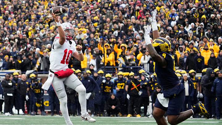 Ohio State Buckeyes quarterback Julian Sayin (10) throws over Michigan Wolverines defensive end Cameron Brandt (9) during the NCAA football game at Michigan Stadium in Ann Arbor, Mich. on Nov. 29, 2025.