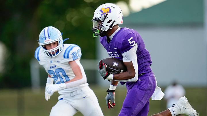 St. Francis DeSales tight end Jordan Karhoff (5) runs past Olentangy Berlin linebacker Chase Arnold (20) during Week 1 of high school football at DeSales High School on Aug. 22, 2025.