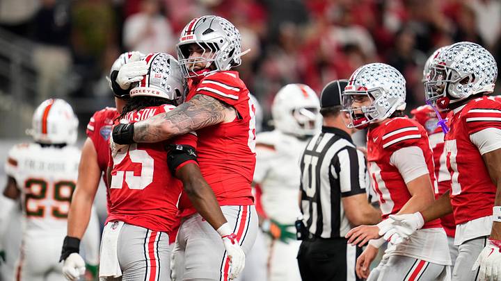 Ohio State Buckeyes offensive lineman Ian Moore (69) hugs running back Bo Jackson (25) after a touchdown during the Cotton Bowl at AT&T Stadium in Arlington, Texas for the College Football Playoff quarterfinal game against the Miami Hurricanes on Dec. 31, 2025. Ohio State lost 24-14.