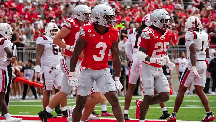 Ohio State Buckeyes wide receiver Devin McCuin (3) celebrates a touchdown with teammates during the NCAA football game against the Ball State Cardinals at Ohio Stadium in Columbus on Sept. 5, 2026.
