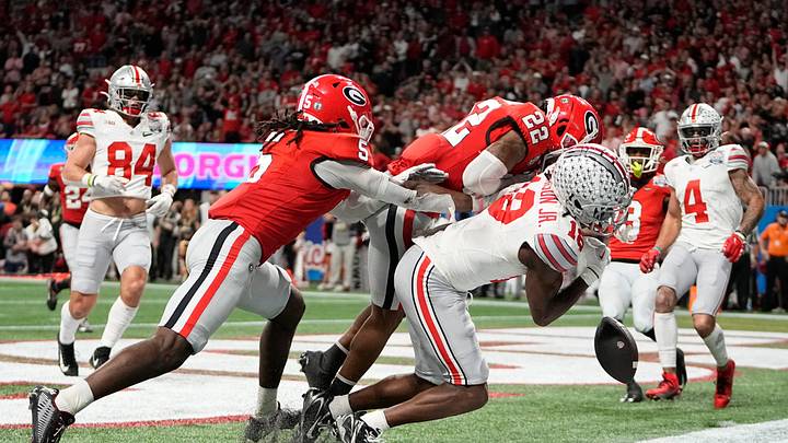 Dec 31, 2022; Atlanta, Georgia, USA; Ohio State wide receiver Marvin Harrison Jr. (18) takes a hit from Georgia defensive back Javon Bullard (22) during the Peach Bowl in the College Football Playoff semifinal at Mercedes-Benz Stadium. Ohio State lost 42-41. Dec 31, 2022; Atlanta, Georgia, USA; Ohio State wide receiver Marvin Harrison Jr. (18) takes a hit from Georgia defensive back Javon Bullard (22) during the Peach Bowl in the College Football Playoff semifinal at Mercedes-Benz Stadium. Ohio State lost 42-41.