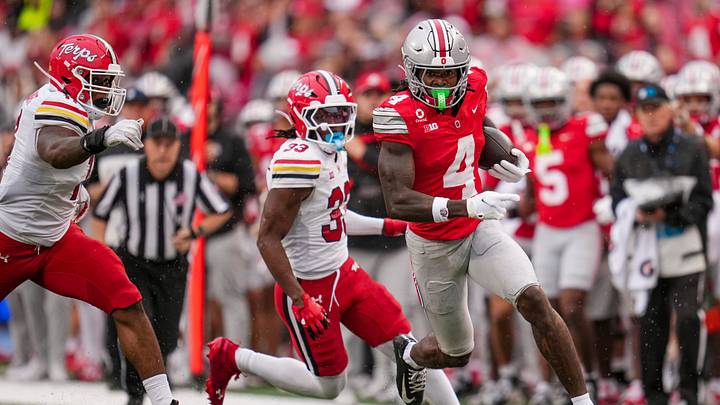 Ohio State Buckeyes wide receiver Jeremiah Smith (4) scores a touchdown past Maryland Terrapins defensive back Messiah Delhomme (33) during the NCAA football game at Ohio Stadium in Columbus on Oct. 10, 2026. Ohio State Buckeyes wide receiver Jeremiah Smith (4) scores a touchdown past Maryland Terrapins defensive back Messiah Delhomme (33) during the NCAA football game at Ohio Stadium in Columbus on Oct. 10, 2026.