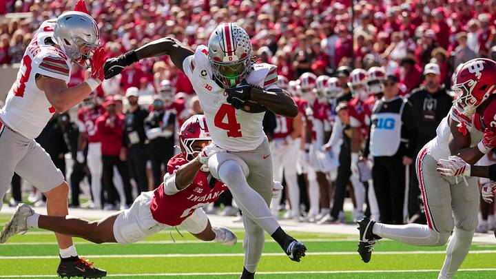 Ohio State Buckeyes wide receiver Jeremiah Smith (4) runs past Indiana Hoosiers defensive back Byron Baldwin Jr. (2) after making a catch during the NCAA football game at Memorial Stadium Stadium in Bloomington, Ind. on Oct. 17, 2026. Ohio State Buckeyes wide receiver Jeremiah Smith (4) runs past Indiana Hoosiers defensive back Byron Baldwin Jr. (2) after making a catch during the NCAA football game at Memorial Stadium Stadium in Bloomington, Ind. on Oct. 17, 2026.