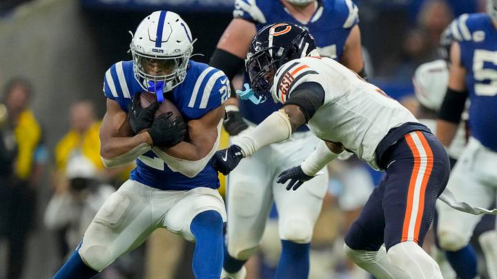 Indianapolis Colts running back Jonathan Taylor eludes former Bears safety Jaquan Brisker. Indianapolis Colts running back Jonathan Taylor eludes former Bears safety Jaquan Brisker.