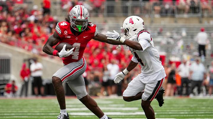 Ohio State Buckeyes wide receiver Jeremiah Smith (4) runs past Ball State Cardinals defensive back Willizhuan Yates (4) during the NCAA football game at Ohio Stadium in Columbus on Sept. 5, 2026. Ohio State Buckeyes wide receiver Jeremiah Smith (4) runs past Ball State Cardinals defensive back Willizhuan Yates (4) during the NCAA football game at Ohio Stadium in Columbus on Sept. 5, 2026.