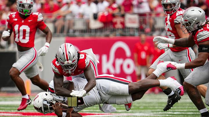 Ohio State Buckeyes safety Jaylen McClain (8) tackles Ball State Cardinals quarterback Keldric Luster (6) during the NCAA football game at Ohio Stadium in Columbus on Sept. 5, 2026. Ohio State Buckeyes safety Jaylen McClain (8) tackles Ball State Cardinals quarterback Keldric Luster (6) during the NCAA football game at Ohio Stadium in Columbus on Sept. 5, 2026.