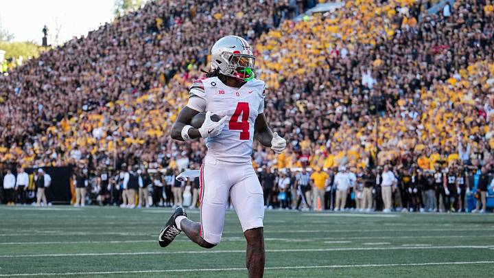 Ohio State Buckeyes wide receiver Jeremiah Smith (4) scores a touchdown, breaking the school's all-time record, during the NCAA football game against the Iowa Hawkeyes at Kinnick Stadium in Iowa City on Oct. 3, 2026. Ohio State on 31-14.
