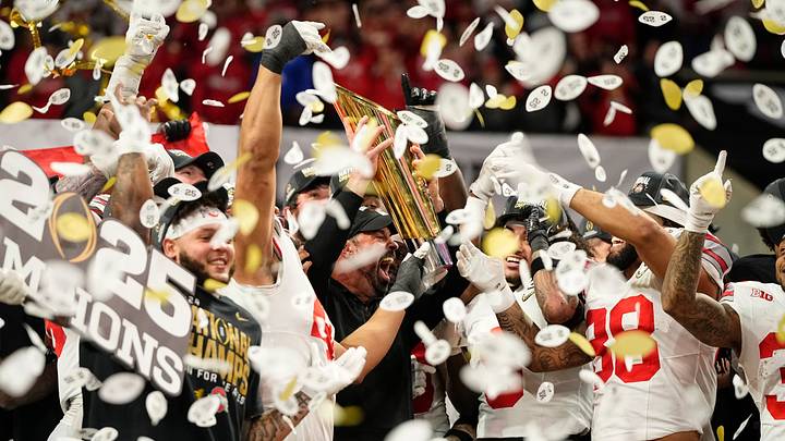 Ohio State Buckeyes head coach Ryan Day and players celebrate with the trophy following the 34-23 win over the Notre Dame Fighting Irish to win the College Football Playoff National Championship at Mercedes-Benz Stadium in Atlanta on Jan. 22, 2025.