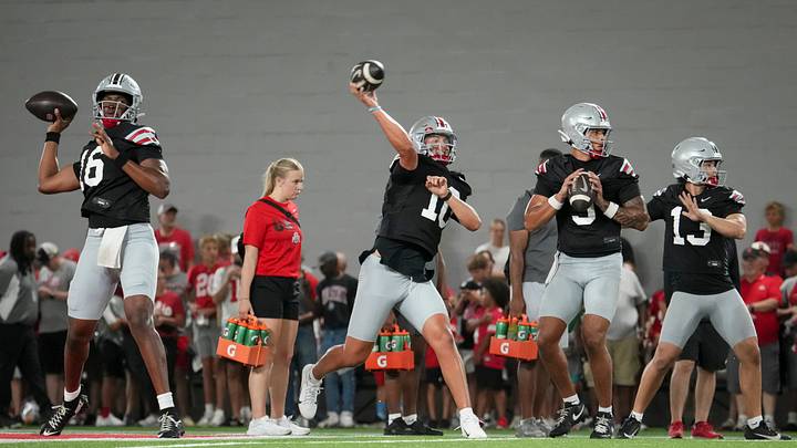 Ohio State Buckeyes quarterbacks, from left, Justyn Martin (16), Julian Sayin (10), Tavien St. Clair (9) and Luke Fahey (13) throw during football training camp inside the Woody Hayes Athletic Center in Columbus on Aug. 7, 2026. Ohio State Buckeyes quarterbacks, from left, Justyn Martin (16), Julian Sayin (10), Tavien St. Clair (9) and Luke Fahey (13) throw during football training camp inside the Woody Hayes Athletic Center in Columbus on Aug. 7, 2026.