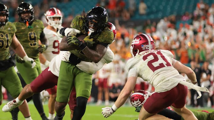 Oct 25, 2025; Miami Gardens, Florida, USA; Miami Hurricanes running back Mark Fletcher Jr. (4) carries the football against Stanford Cardinal safety Mitch Leigber (32) and safety Scotty Edwards (21) during the third quarter at Hard Rock Stadium. Mandatory Credit: Sam Navarro-Imagn Images