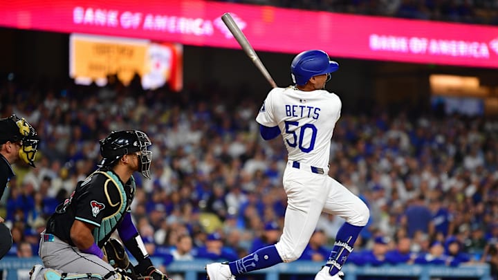 May 19, 2025; Los Angeles, California, USA; Los Angeles Dodgers shortstop Mookie Betts (50) hits a solo home run against the Arizona Diamondbacks during the sixth inning at Dodger Stadium. Mandatory Credit: Gary A. Vasquez-Imagn Images