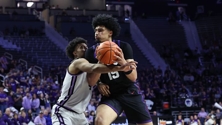 Feb 28, 2026; Manhattan, Kansas, USA; TCU Horned Frogs forward David Punch (15) goes to the basket against Kansas State Wildcats guard P.J. Haggerty (4) during the first half at Bramlage Coliseum. Mandatory Credit: Scott Sewell-Imagn Images