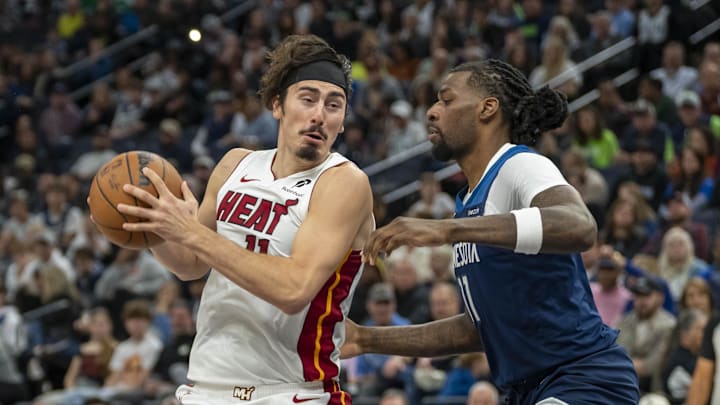 Nov 10, 2024; Minneapolis, Minnesota, USA; Miami Heat guard Jaime Jaquez Jr. (11) drives to the basket past Minnesota Timberwolves center Naz Reid (11) in the second half at Target Center. Mandatory Credit: Jesse Johnson-Imagn Images
