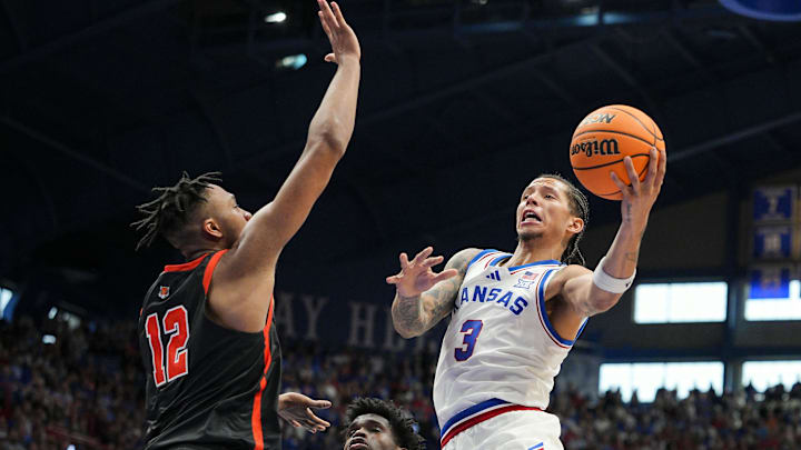 Nov 15, 2025; Lawrence, Kansas, USA; Kansas Jayhawks guard Tre White (3) shoots against Princeton Tigers forward Jacob Huggins (12) and forward Malik Abdullahi (7) during the second half at Allen Fieldhouse. Mandatory Credit: Jay Biggerstaff-Imagn Images Nov 15, 2025; Lawrence, Kansas, USA; Kansas Jayhawks guard Tre White (3) shoots against Princeton Tigers forward Jacob Huggins (12) and forward Malik Abdullahi (7) during the second half at Allen Fieldhouse. Mandatory Credit: Jay Biggerstaff-Imagn Images