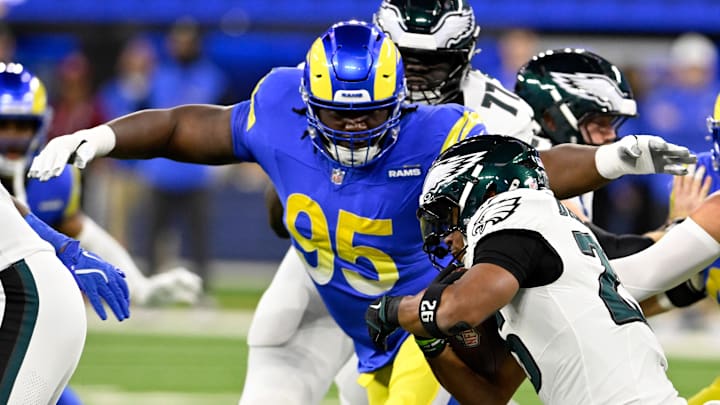 Nov 24, 2024; Inglewood, California, USA; Los Angeles Rams defensive tackle Bobby Brown III (95) tackles Philadelphia Eagles running back Saquon Barkley (26) during the first half at SoFi Stadium. Mandatory Credit: Alex Gallardo-Imagn Images Nov 24, 2024; Inglewood, California, USA; Los Angeles Rams defensive tackle Bobby Brown III (95) tackles Philadelphia Eagles running back Saquon Barkley (26) during the first half at SoFi Stadium. Mandatory Credit: Alex Gallardo-Imagn Images