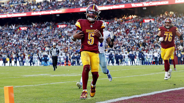 Nov 24, 2024; Landover, Maryland, USA; Washington Commanders quarterback Jayden Daniels (5) scores a two point conversion during the fourth quarter against the Dallas Cowboys at Northwest Stadium. Mandatory Credit: Peter Casey-Imagn Images