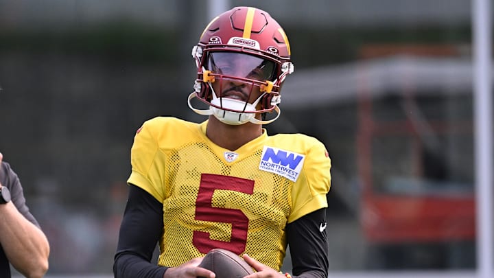 Aug 6, 2025; Foxborough, MA, USA; Washington Commanders quarterback Jayden Daniels (5) with the ball at training camp at Gillette Stadium. Mandatory Credit: Eric Canha-Imagn Images