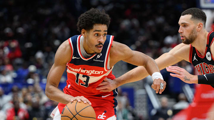Jan 1, 2025; Washington, District of Columbia, USA; Washington Wizards guard Jordan Poole (13) drives to the basket against Chicago Bulls guard Zach LaVine (8) during the second quarter at Capital One Arena. Mandatory Credit: Reggie Hildred-Imagn Images
