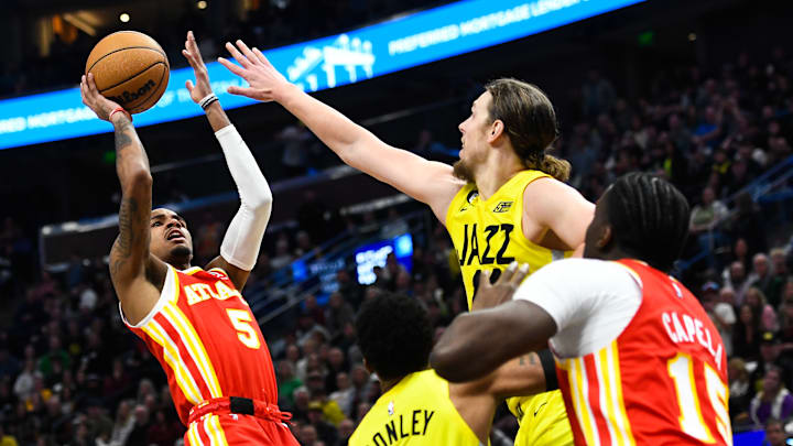Dejounte Murray shoots over Kelly Olynyk as the Utah Jazz face the Atlanta Hawks.
