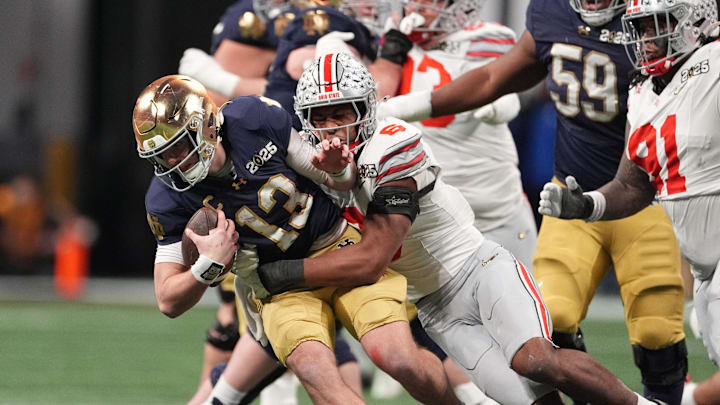 Jan 20, 2025; Atlanta, GA, USA; Notre Dame Fighting Irish quarterback Riley Leonard (13) is tackled by Ohio State Buckeyes safety Sonny Styles (6) in the second half in the CFP National Championship college football game at Mercedes-Benz Stadium. Mandatory Credit: Dale Zanine-Imagn Images