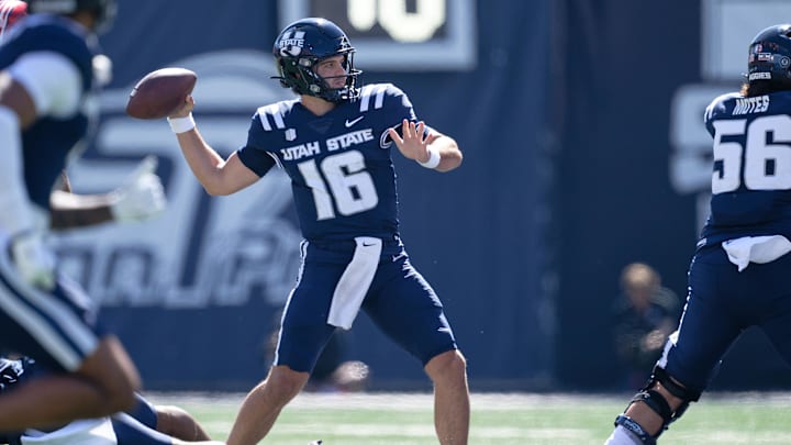 Utah State Aggies quarterback Bryson Barnes (16) passes against the Utah Utes at Merlin Olsen Field at Maverik Stadium. Utah State Aggies quarterback Bryson Barnes (16) passes against the Utah Utes at Merlin Olsen Field at Maverik Stadium.