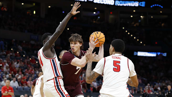 Mar 21, 2026; Oklahoma City, OK, USA; Texas A&M Aggies forward Zach Clemence (7) drives to the hoop past Houston Cougars forward Chase McCarty (24) and center Chris Cenac Jr. (5) during the first half of a second round game of the men's 2026 NCAA Tournament at Paycom Center. Mandatory Credit: Alonzo Adams-Imagn Images