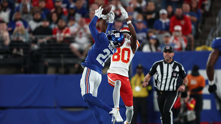Sep 21, 2025; East Rutherford, New Jersey, USA;  New York Giants cornerback Paulson Adebo (21) breaks up a pass against Kansas City Chiefs wide receiver Tyquan Thornton (80) in the second quarter at MetLife Stadium. Mandatory Credit: Vincent Carchietta-Imagn Images