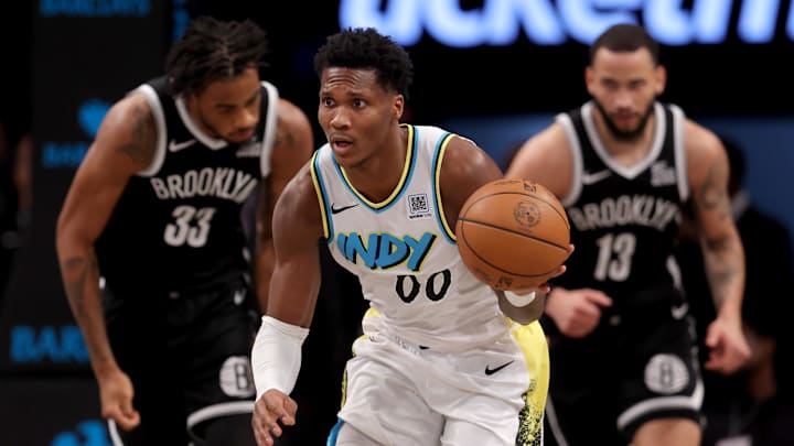 Jan 6, 2025; Brooklyn, New York, USA; Indiana Pacers guard Bennedict Mathurin (00) brings the ball up court against Brooklyn Nets center Nic Claxton (33) and guard Tyrese Martin (13) during the second quarter at Barclays Center. Mandatory Credit: Brad Penner-Imagn Images